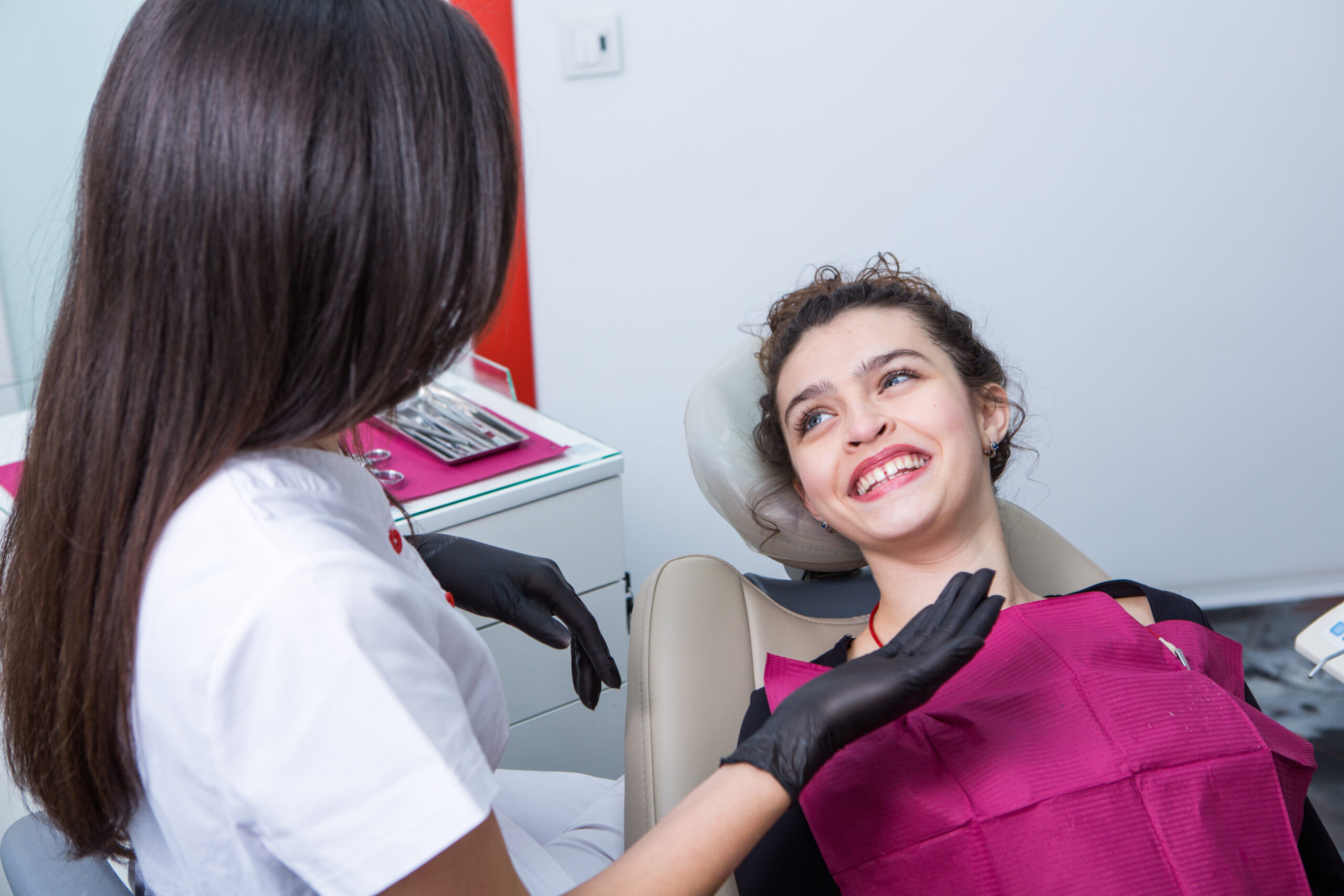 Dentist examining teeth of a young woman patient in a dental clinic. Dentistry concept. Dentist and patient in the dental office.