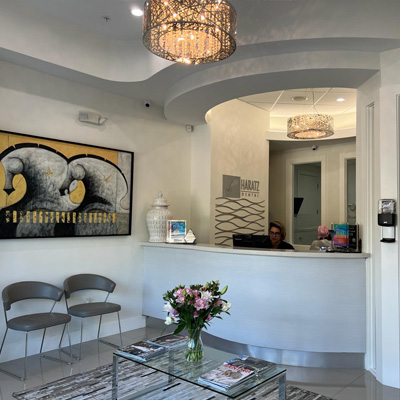 Haratz Dental reception area with front desk, waiting chairs, and modern décor